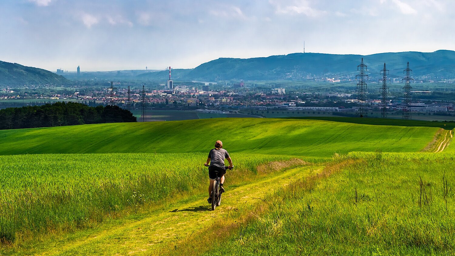 Photograph: Biker on hill in front of a town